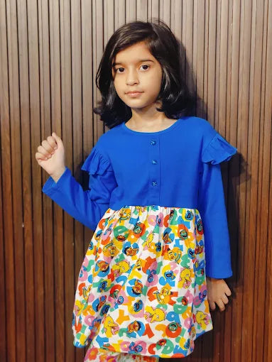 Girl wearing a blue MODST ruffle top with a printed skirt